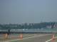 The boats are lined up along the log boom (beyond the police officer)